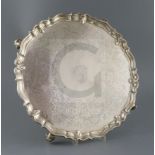 A George II silver shaped circular salver by John Tuite, with piecrust border and later engraved
