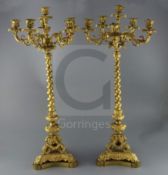 A pair of 19th century French ormolu six light candelabra, with scroll and mask branches, spiral