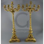 A pair of 19th century French ormolu six light candelabra, with scroll and mask branches, spiral