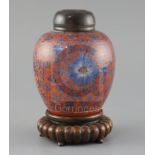 A Chinese coral red ground underglaze blue jar, Kangxi period, painted with flowerheads and