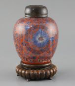 A Chinese coral red ground underglaze blue jar, Kangxi period, painted with flowerheads and