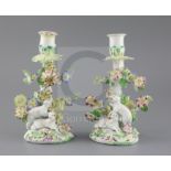 A pair of early Derby 'sheep' candlesticks, c.1758, each modelled with two sheep below a flower