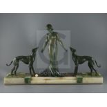 P. Huguenot. An Art Deco bronze and three coloured onyx group of a medieval lady and two hounds,