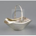 A late Victorian silver Hukin and Heath sugar basket, designed by Christopher Dresser, of boat