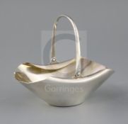 A late Victorian silver Hukin and Heath sugar basket, designed by Christopher Dresser, of boat
