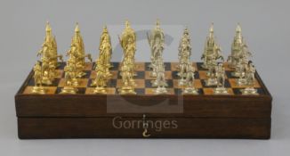 A figural silvered and gilded metal chess set in fitted rosewood and boxwood folding box/chess