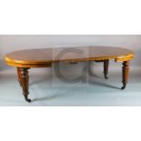 A Victorian figure and burr walnut extending dining table, with demi lune ends and carved turned and