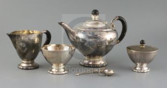 A 1920's Danish Georg Jensen matched sterling silver four piece tea set, together with a caddy spoon