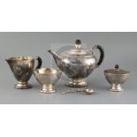 A 1920's Danish Georg Jensen matched sterling silver four piece tea set, together with a caddy spoon