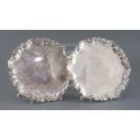 A pair of George II Irish silver salvers by John Laughlin Senior, of shaped circular form, with