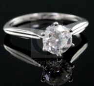 A modern 18ct white gold and solitaire diamond ring, the stone weighing approximately 1.00ct, size