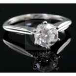 A modern 18ct white gold and solitaire diamond ring, the stone weighing approximately 1.00ct, size