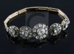 An antique gold and graduated quintuple diamond cluster set bracelet (a.f.), set with rose and rough