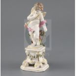 A Bow porcelain figure of Cupid, c. 1765-70, holding his bow and standing on a square pedestal