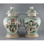 A pair of Chinese famille rose jars and covers, late 19th century, each painted with panels of