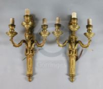 A pair of Adam revival ormolu three branch wall lights, with flaming urn and goat's head backplates,