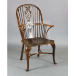 An early 19th century yew, ash and elm Windsor chair, with ornate carved and pierced splat,