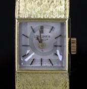 A lady's 18ct gold Longines manual wind wrist watch, with square dial and baton numerals, on