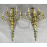 A pair of late Victorian ornate cast brass five branch wall lights, modelled with ribbon stems,