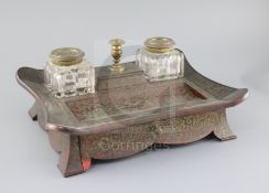 A mid 19th century red boulle work inkstand, with central taperstick lidded box, flanked by cut