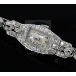 A lady's platinum and diamond set manual wind cocktail watch, with rectangular Arabic dial and