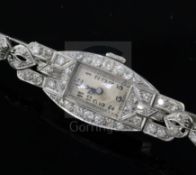 A lady's platinum and diamond set manual wind cocktail watch, with rectangular Arabic dial and