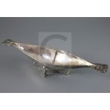A George V Arts and Crafts Omar Ramsden planished silver two handled boat shaped dish, with