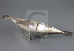A George V Arts and Crafts Omar Ramsden planished silver two handled boat shaped dish, with