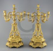 A pair of late 19th century French ormolu six light candelabra, with foliate scroll vineous