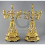 A pair of late 19th century French ormolu six light candelabra, with foliate scroll vineous