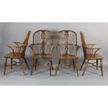 A near set of four 19th century yew, ash and elm Windsor chairs, with wheel backs, saddle seats