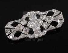 A 1930's/1940's pierced platinum? and diamond set brooch, of shaped rectangular form, set with old