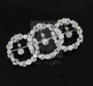 A 1920's white gold and round and rose cut diamond set interlocking triple circle openwork drop