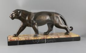 A French Art Deco PATINATED SPELTER model of a prowling panther, on two colour marble plinth