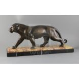 A French Art Deco PATINATED SPELTER model of a prowling panther, on two colour marble plinth