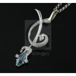 A stylish modern platinum, shaped cut aquamarine and diamond set spray pendant, on a 9ct white