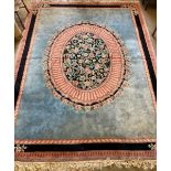 An Indian floral medallion carpet, with a sky blue field within a pink and blue border, 375 x282cm