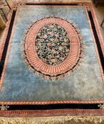 An Indian floral medallion carpet, with a sky blue field within a pink and blue border, 375 x282cm