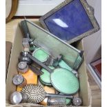 A silver mounted photograph frame, silver lidded cut glass toilet jars and an Art Deco toilet set