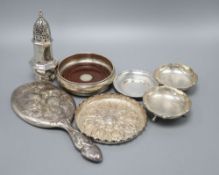 A pair of Indian white metal bon-bon dishes, a modern wine coaster, a Victorian embossed circular