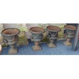A set of four cast iron campana-shaped urns, H.59cm, W.43cm