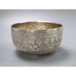 An Indian white metal sugar bowl decorated with a continuous frieze of animals in the jungle,