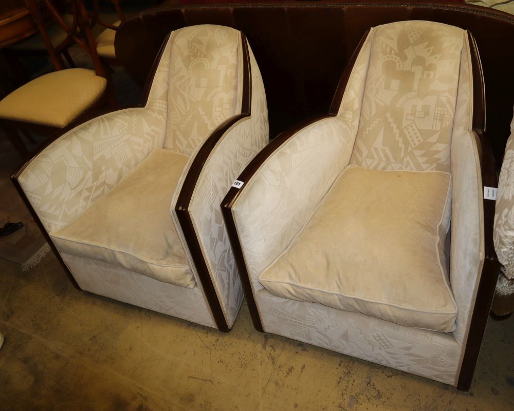A pair of 1930's French Art Deco walnut framed armchairs, with deco design cream upholstery, W.69cm,