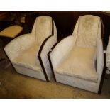 A pair of 1930's French Art Deco walnut framed armchairs, with deco design cream upholstery, W.69cm,