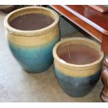 A graduated pair of glazed ceramic garden planters, largest W.48cm, H.51cm