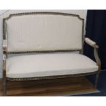 A Louis XVI style painted and parcel gilt settee, W.128cm