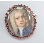A George III portrait miniature of a gentleman, garnet frame