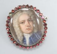 A George III portrait miniature of a gentleman, garnet frame