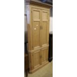 A 19th century pine four door standing corner cabinet, W.98cm