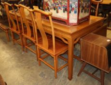 A Chinese dining table and six chairs, table W.216cm, D.86cm, H.84cm